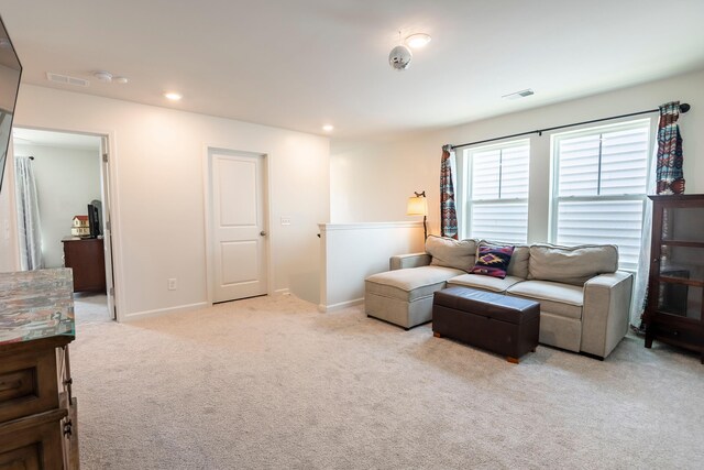 living area featuring light carpet, baseboards, and recessed lighting