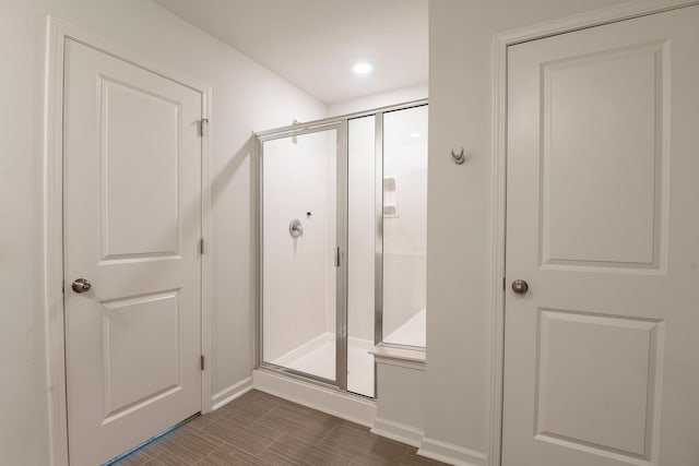 full bathroom featuring baseboards, a stall shower, and recessed lighting