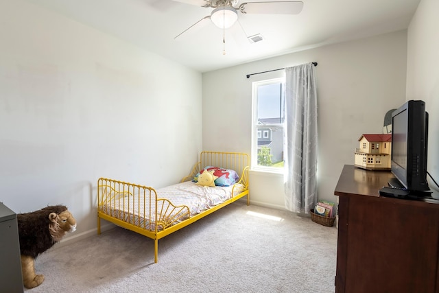 carpeted bedroom with baseboards and ceiling fan