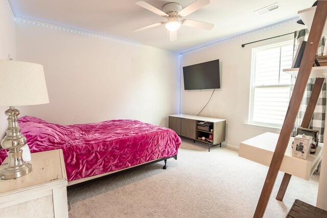 bedroom featuring light carpet and a ceiling fan
