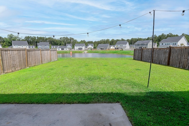 view of yard with a water view and a residential view