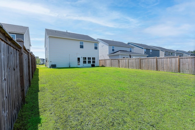back of house featuring a residential view and central AC unit