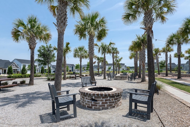 view of patio with an outdoor fire pit, a residential view, and cooling unit