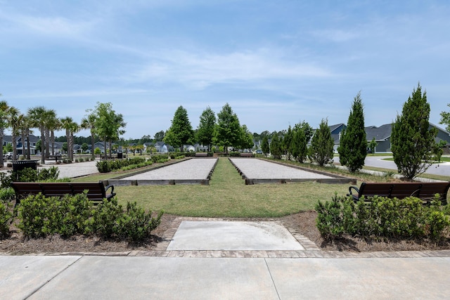 view of community with a bocce ball area, a yard, and a residential view