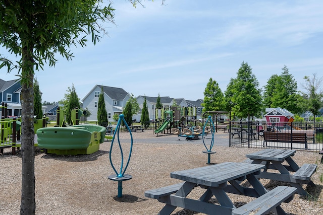 community playground with fence and a residential view