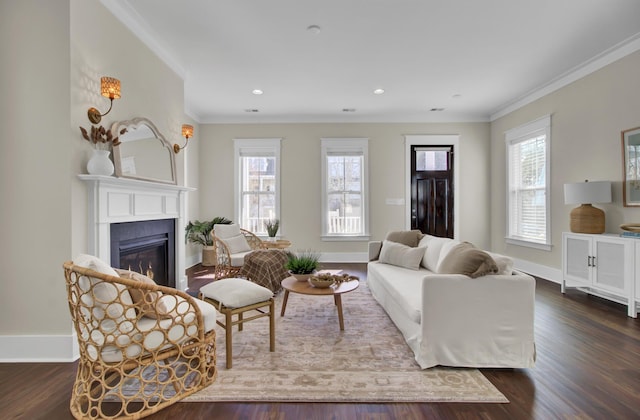 living room with a healthy amount of sunlight, dark hardwood / wood-style flooring, and crown molding