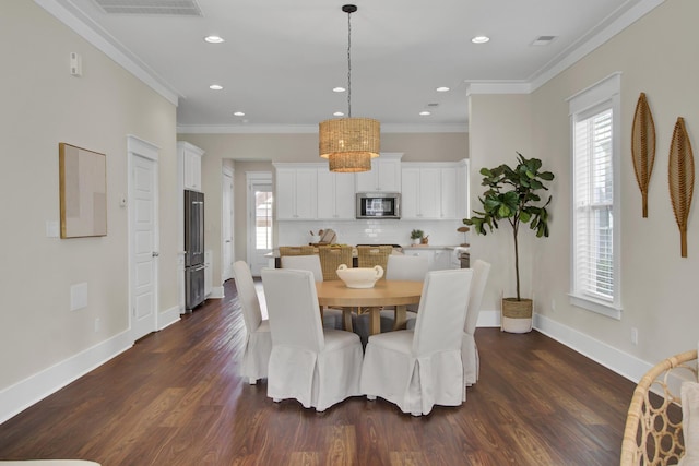 dining area with dark hardwood / wood-style floors and ornamental molding