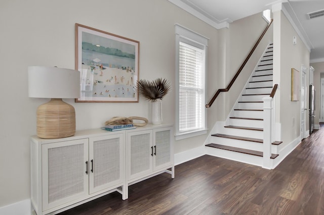 stairs with wood-type flooring, a wealth of natural light, and ornamental molding