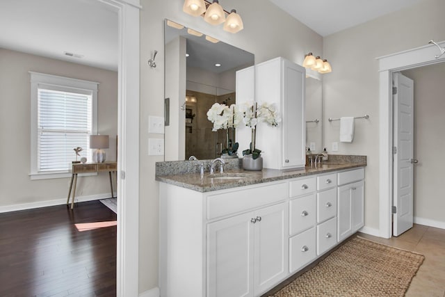 bathroom featuring walk in shower and vanity