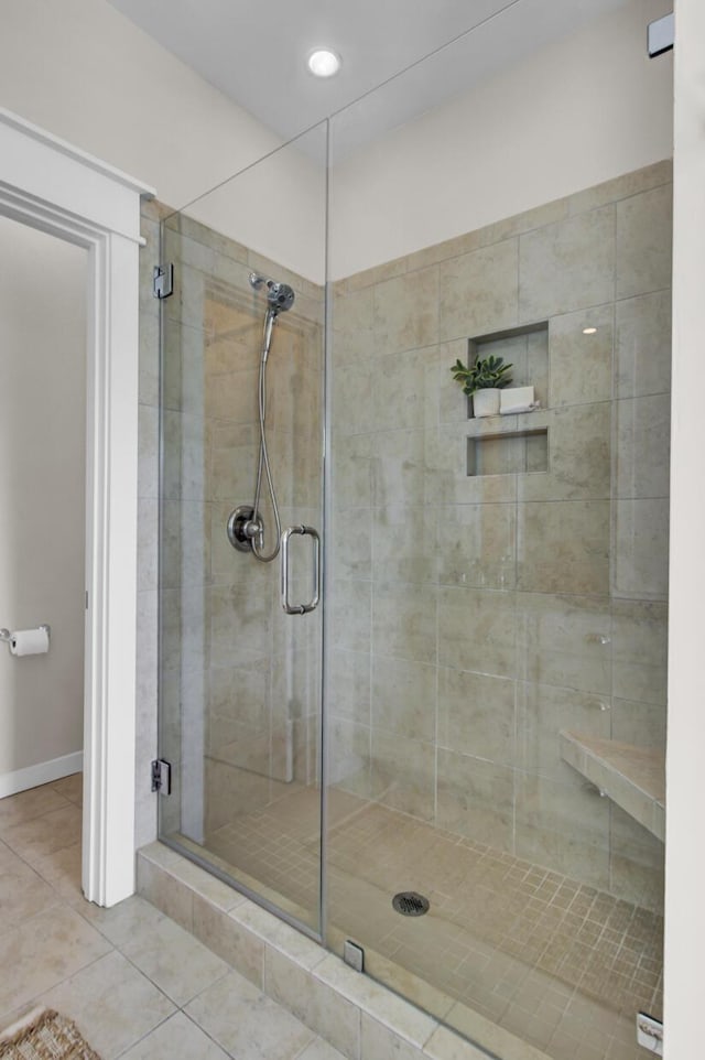 bathroom with tile patterned floors and walk in shower