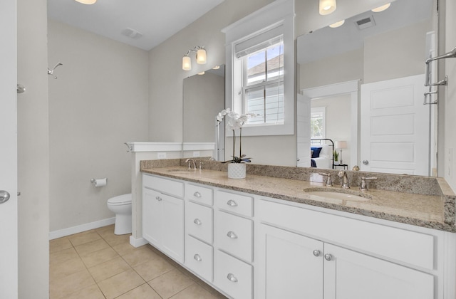 bathroom featuring toilet, tile patterned flooring, and vanity