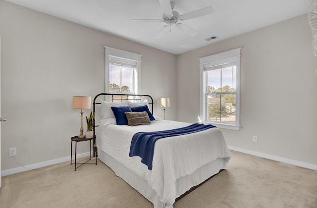 bedroom featuring ceiling fan and light carpet