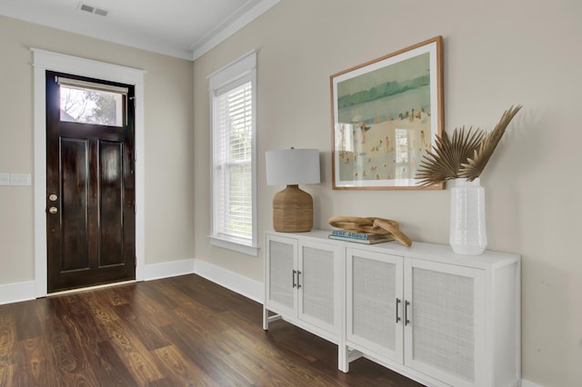 entryway with dark hardwood / wood-style flooring and crown molding