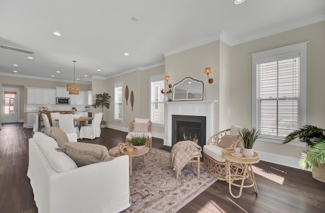 living room with dark wood-type flooring and crown molding