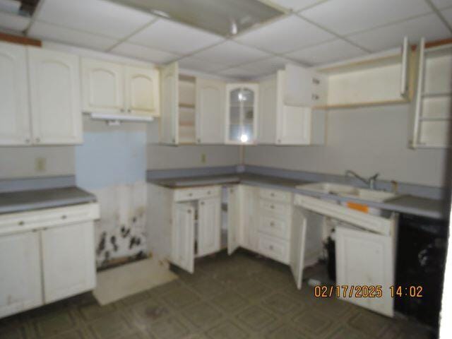 kitchen featuring sink, white cabinets, and a paneled ceiling