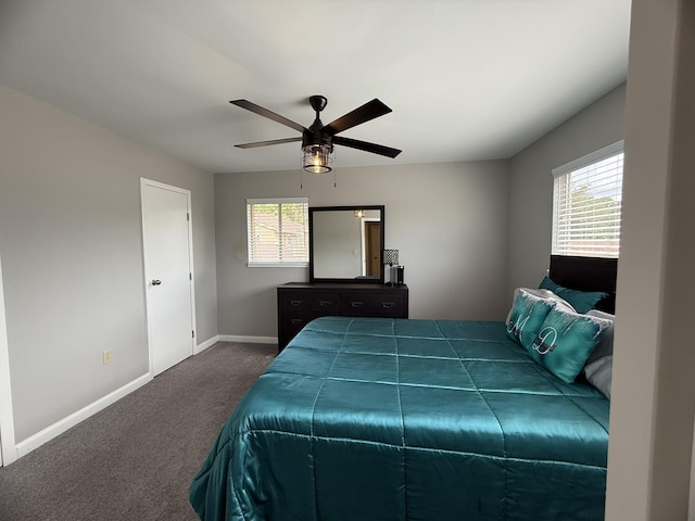 bedroom featuring ceiling fan, dark colored carpet, and baseboards