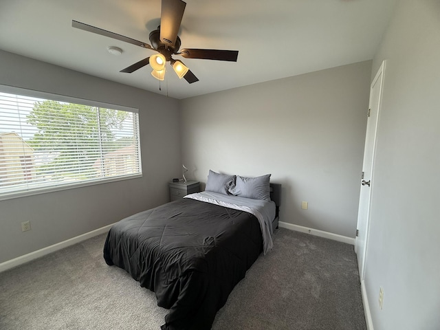 carpeted bedroom featuring baseboards and a ceiling fan