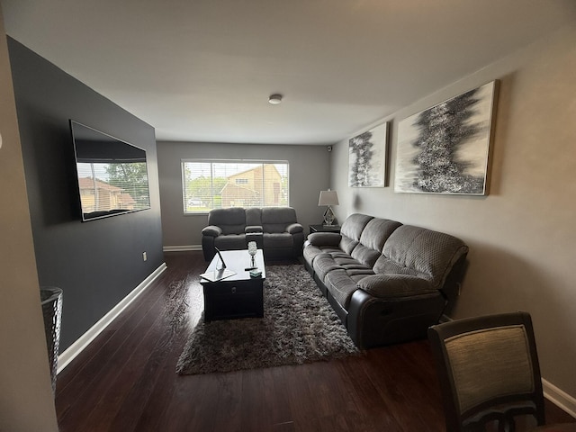 living area featuring wood finished floors and baseboards