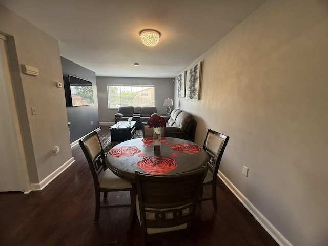 dining room featuring wood finished floors and baseboards