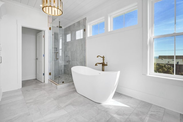 305 Matilda St, Edisto Beach, SC 29438 - full bathroom featuring marble look tiles, a shower stall, a soaking tub, and a chandelier