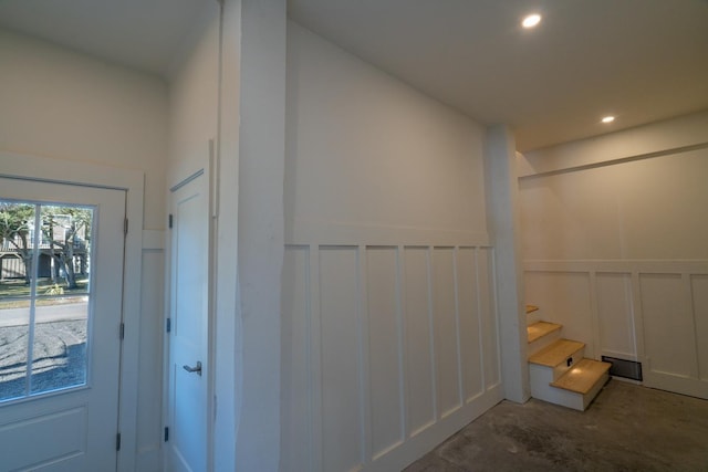 305 Matilda St, Edisto Beach, SC 29438 - hallway with a decorative wall, a wainscoted wall, unfinished concrete floors, and recessed lighting