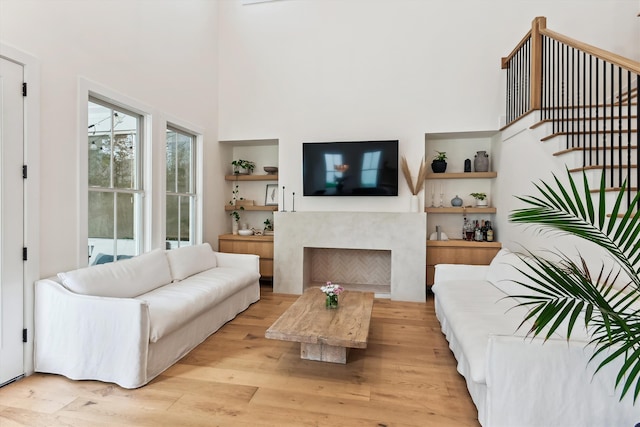 1474 Blue Cascade Dr, Mount Pleasant, SC 29464 - living room with light wood-style flooring, stairway, and a fireplace