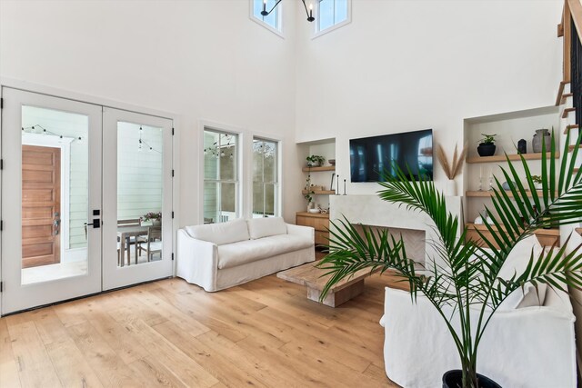 1474 Blue Cascade Dr, Mount Pleasant, SC 29464 - living room featuring light wood finished floors, a high ceiling, and french doors