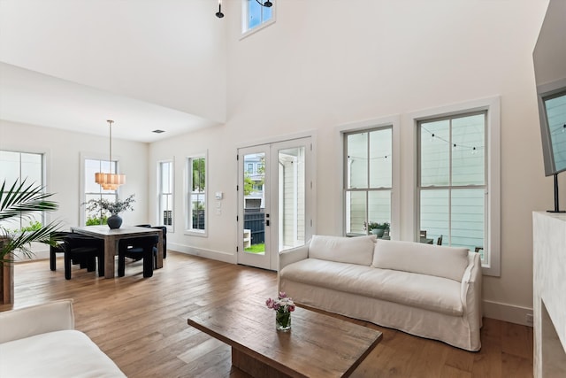 1474 Blue Cascade Dr, Mount Pleasant, SC 29464 - living area with wood finished floors, healthy amount of natural light, baseboards, and a towering ceiling