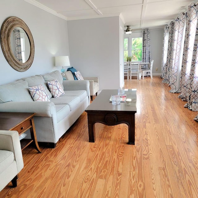 living room featuring ornamental molding, light hardwood / wood-style floors, and ceiling fan