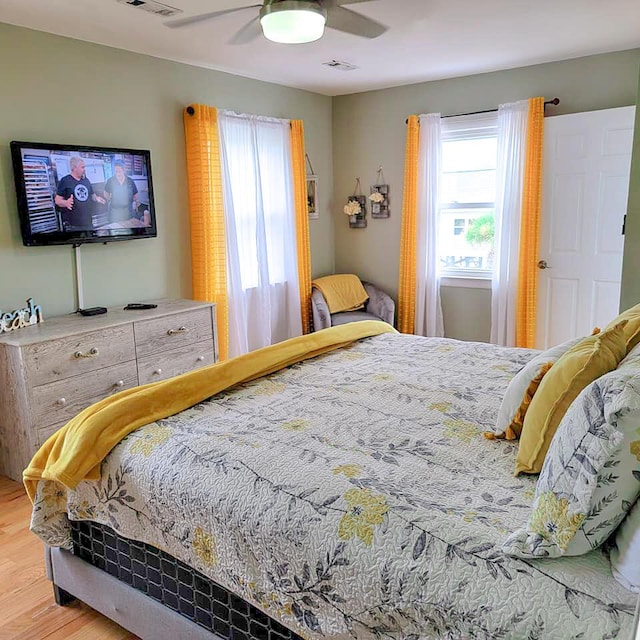 bedroom with ceiling fan and hardwood / wood-style floors