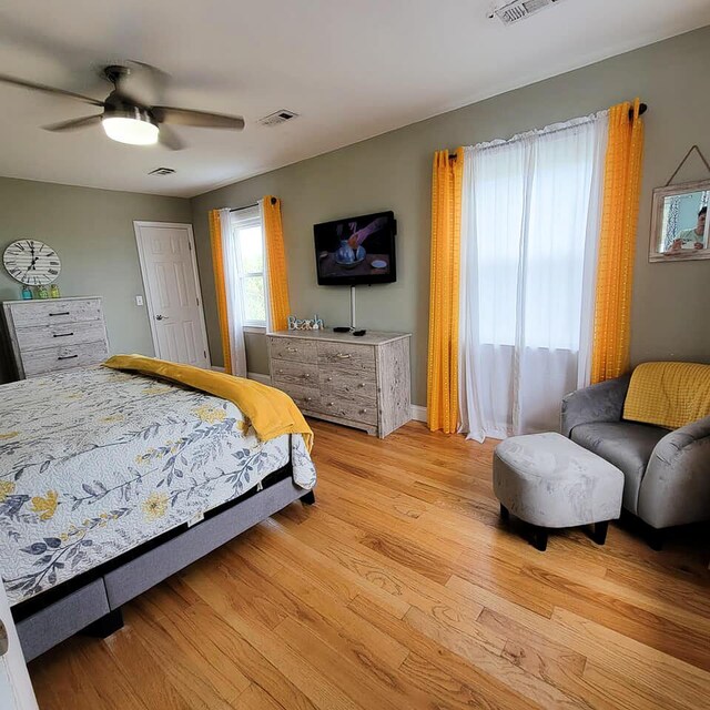 bedroom with light wood-type flooring and ceiling fan