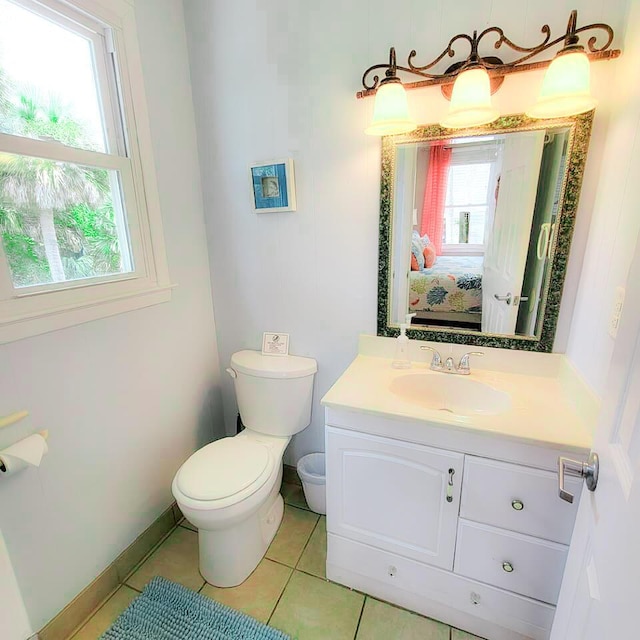 bathroom with tile patterned flooring, vanity, plenty of natural light, and toilet