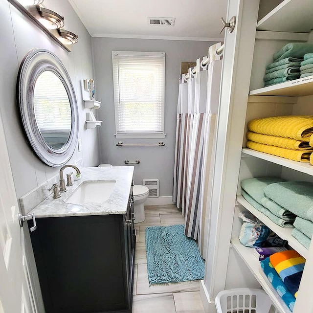 bathroom with vanity, tile patterned floors, and toilet