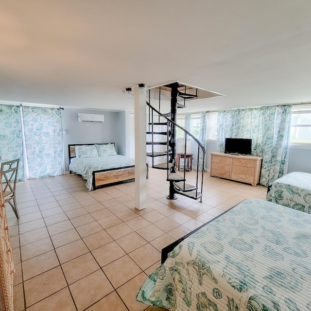 bedroom featuring light tile patterned flooring and an AC wall unit