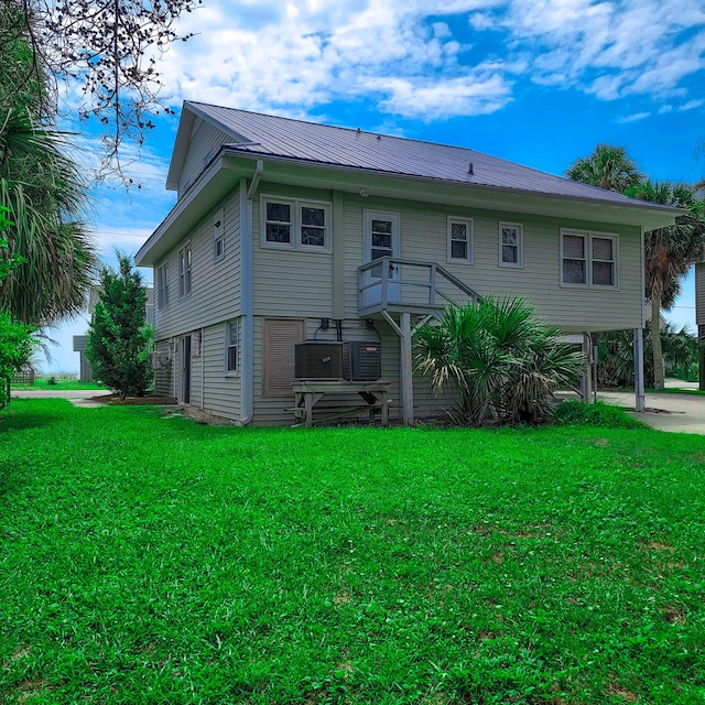 rear view of house with a lawn