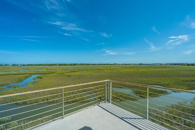 balcony featuring a water view and a rural view