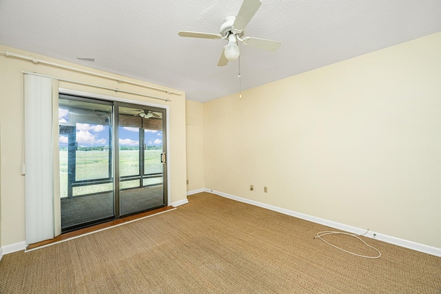 empty room with ceiling fan, carpet, and a textured ceiling