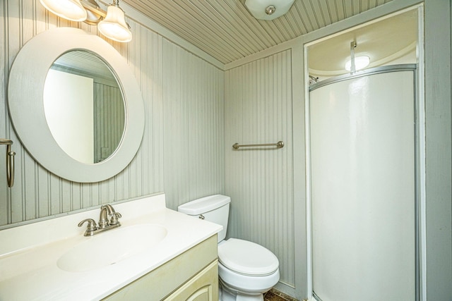 bathroom with walk in shower, vanity, and toilet