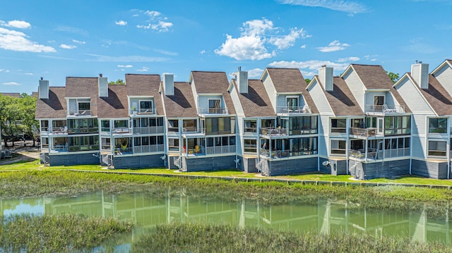 back of property with a water view