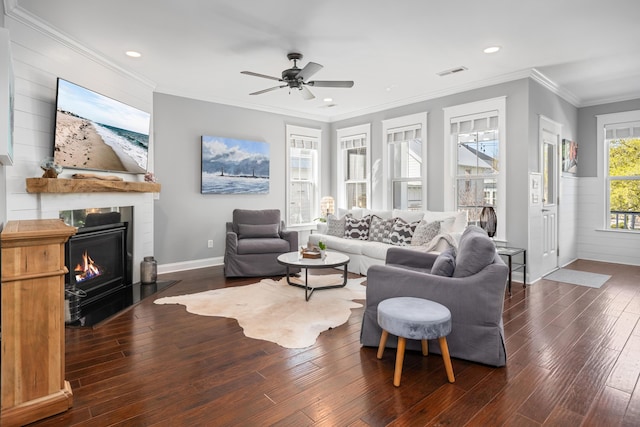 living room with hardwood / wood-style floors, a glass covered fireplace, ceiling fan, visible vents, and recessed lighting