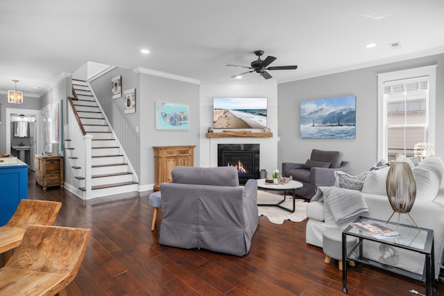 living room featuring recessed lighting, stairway, a fireplace, and ornamental molding