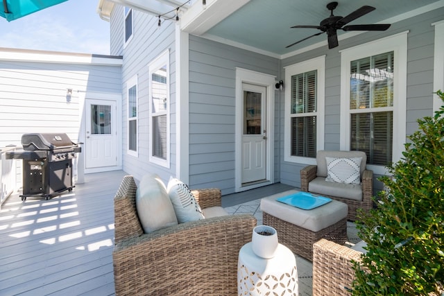 wooden terrace with grilling area and a ceiling fan