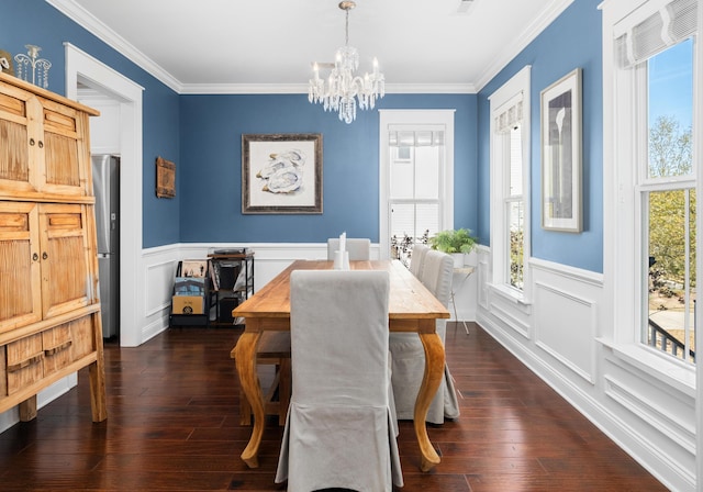 dining room featuring wainscoting, a notable chandelier, and ornamental molding