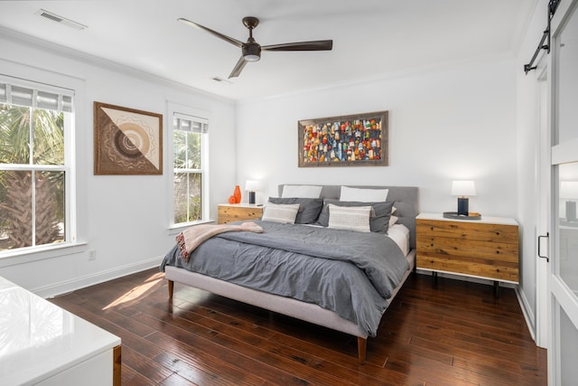 bedroom with visible vents, dark wood-style flooring, ornamental molding, and multiple windows