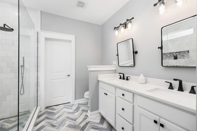bathroom featuring visible vents, a sink, and a shower stall