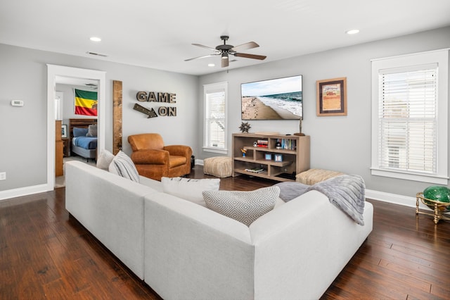 living area featuring visible vents, baseboards, recessed lighting, a ceiling fan, and dark wood-type flooring