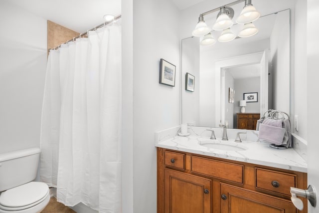 bathroom with vanity, curtained shower, and toilet