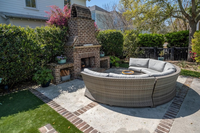 view of patio / terrace with an outdoor living space with a fireplace