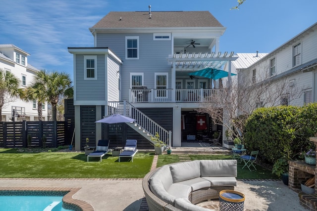 rear view of property with fence, a lawn, stairs, ceiling fan, and a patio