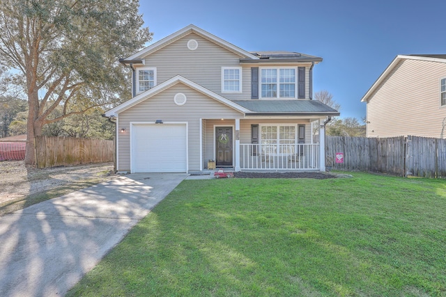 traditional-style house featuring covered porch, driveway, a front lawn, and fence